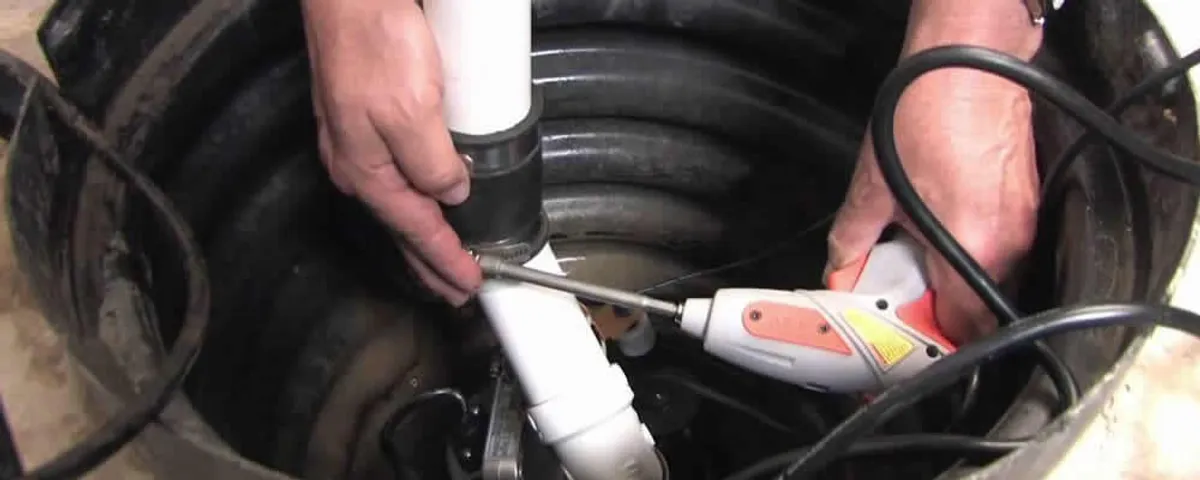 Sump pump installation technician connecting PVC discharge piping in El Paso, TX
